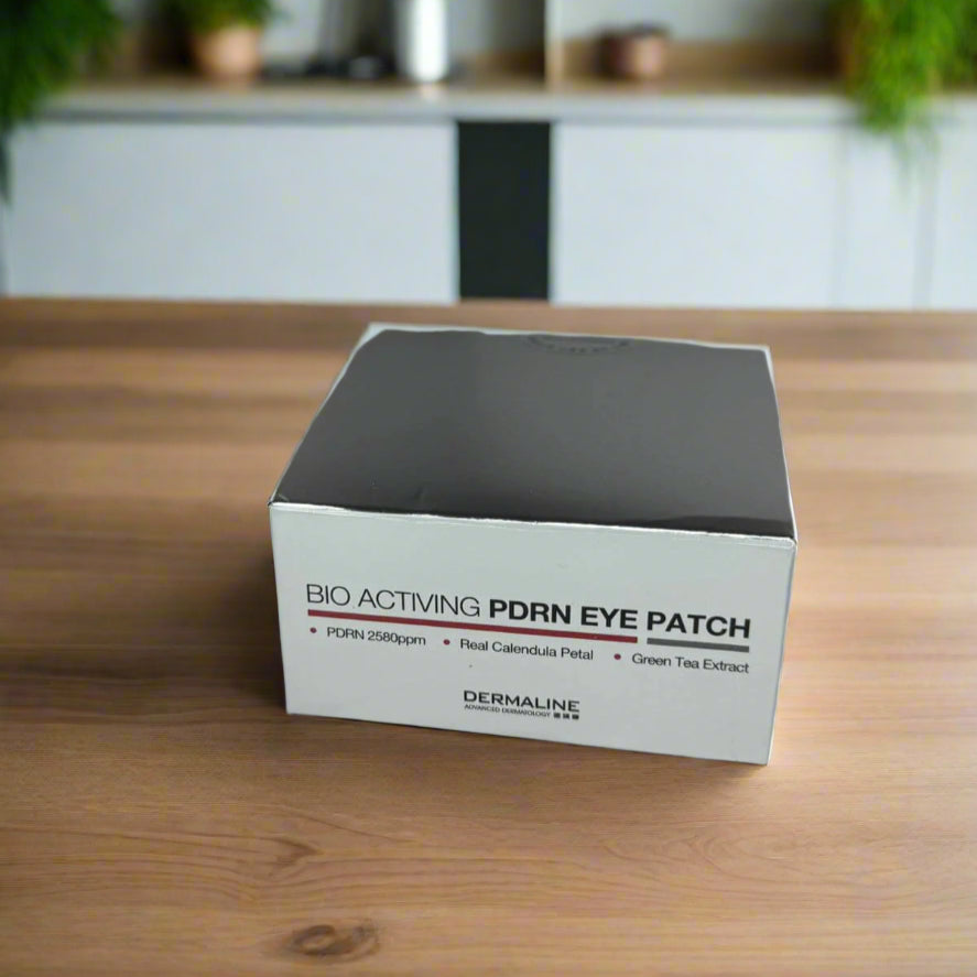 Box of DERMALINE BIO ACTIVING PDRN EYE PATCH on a wooden surface with a kitchen background